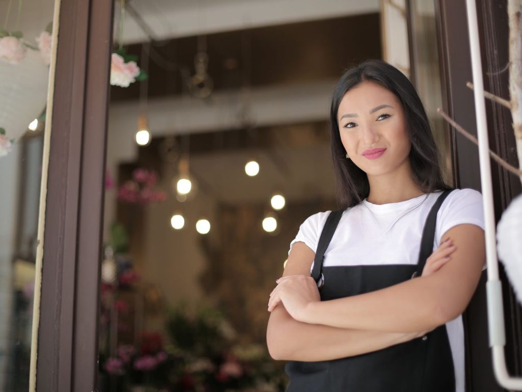 Business owner standing at the entrance of her shop