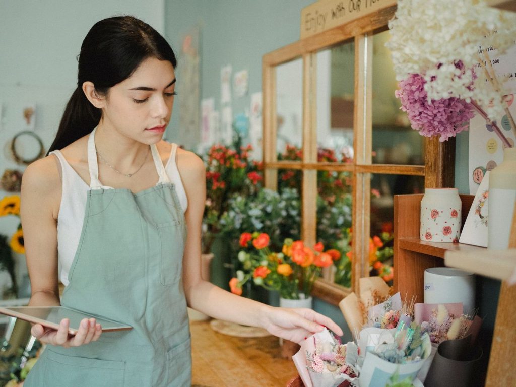 Florist using a tablet in her flower shop