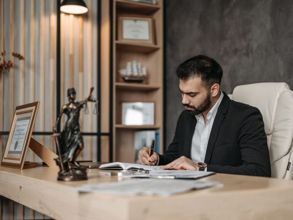 Lawyer reviewing legal documents at a desk in a law office