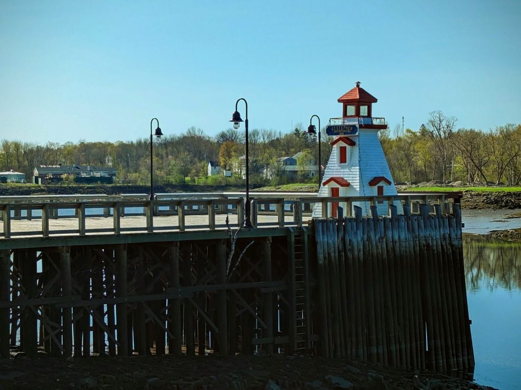 A small lighthouse and wharf on a river