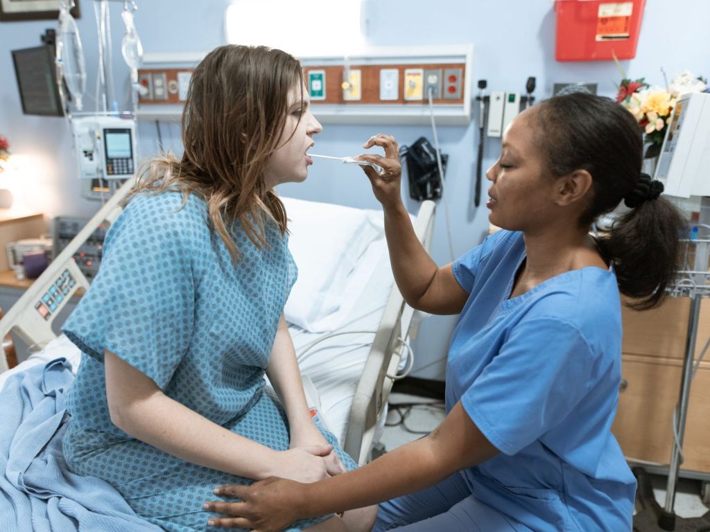 A nurse caring for a patient on a hospital ward