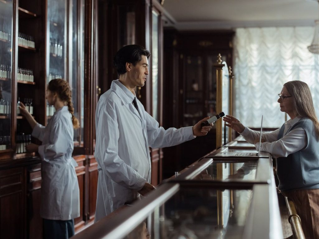 A pharmacist serving a customer at the pharmacy counter