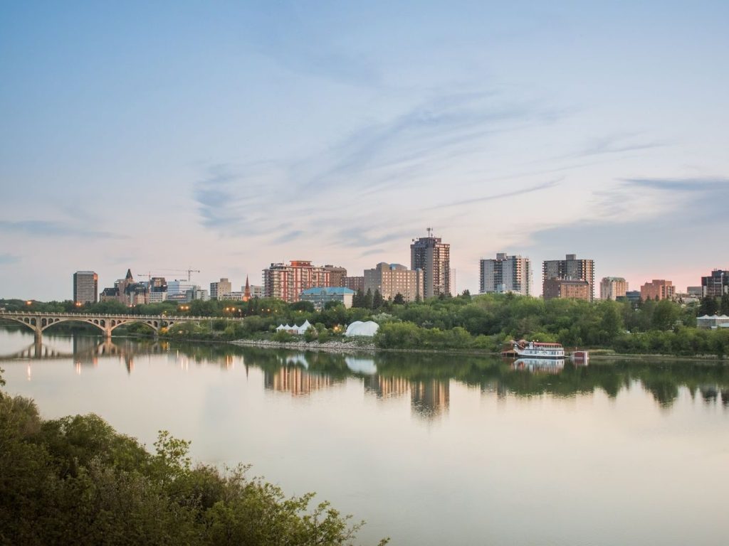 Saskatoon skyline reflected in the South Saskatchewan River at dusk